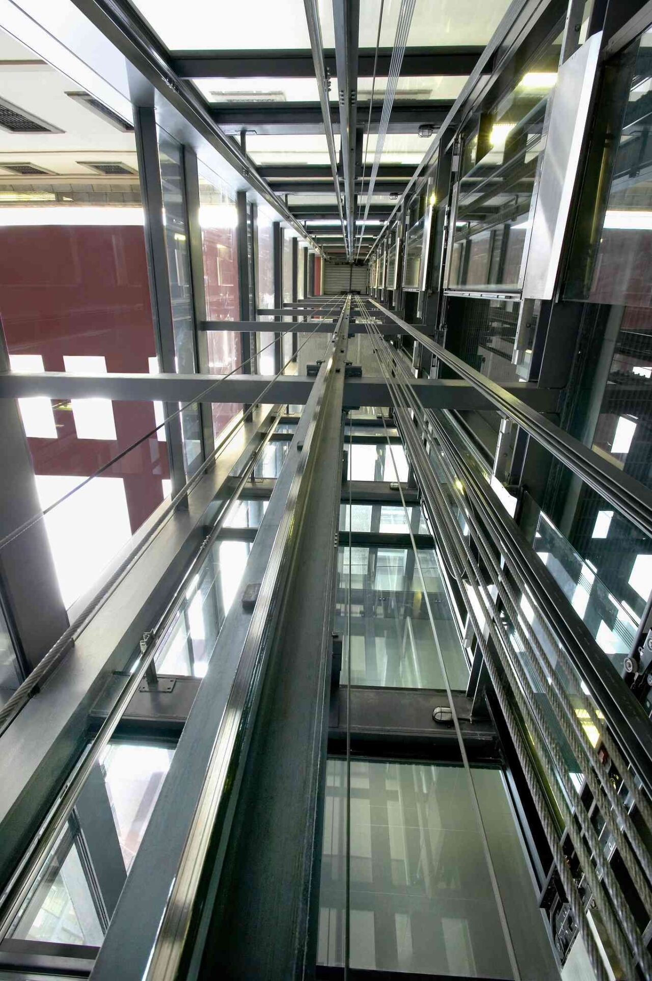 Glass-enclosed elevator shaft showcasing structural elements.